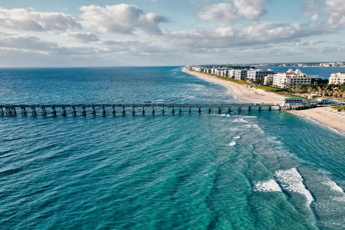 Aerial view of a long fishing pier and beach on Florida's Atlantic coast
